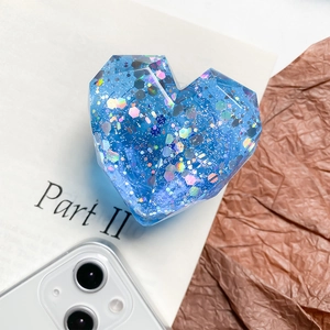 Blue heart-shaped expanding phone grip with iridescent sequins and faceted 3D surface