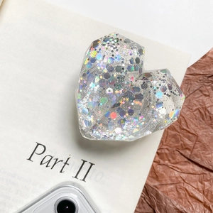 Heart-shaped expanding phone grip featuring vibrant holographic glitter and sequins