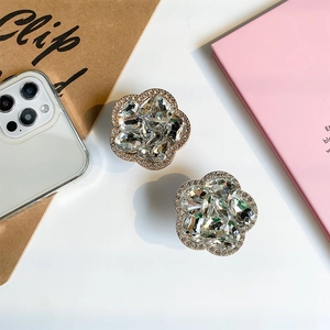 Macro detail of luxury flower phone socket stand with sparkling crystals and silver base