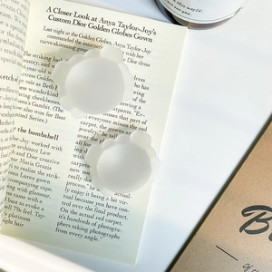 Detailed close-up of seamless petal-shaped silicone nipple covers on a magazine