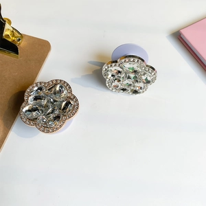 Macro detail of luxury flower phone grip with sparkling rhinestones and folding base