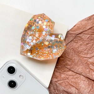 Amber heart-shaped retractable phone grip with iridescent sequins and glitter