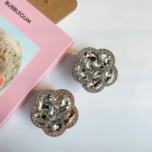 Detailed view of luxury crystal flower phone grips in silver and rose gold finishes