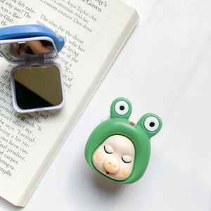 Detail shot of a cute green frog baby-style foldable phone grip with hidden makeup mirror