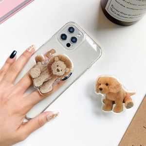 Detail of cute animal phone grip featuring lion and puppy designs on transparent case