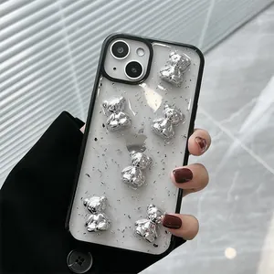 Detail of iPhone case with silver glitter back and 3D metal bears on black frame