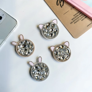Close-up of luxury rhinestone cat and rabbit ear phone grips with sparkling crystal inlay