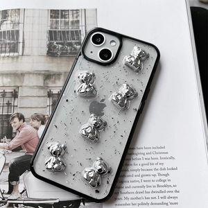 Close-up of stylish silver bears and foil glitter on a liquid glue texture phone case