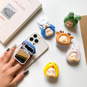 Detail of cute cartoon animal phone grip featuring a built-in makeup mirror and adhesive