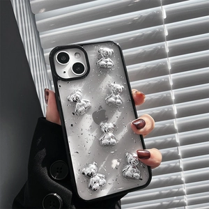 Close-up of iPhone case featuring a 3D silver bear design with sparkling glitter finish