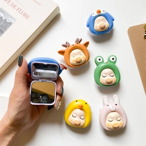 Close-up of portable animal-shaped makeup mirrors with a flip-top design and clear reflection