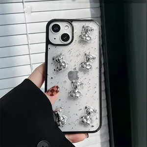 Close-up of clear iPhone case with silver foil glitter and 3D metallic bear ornaments
