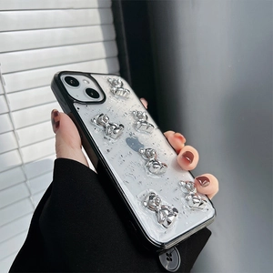 Detail of creative silver foil phone case with 3D plated bear figurines for iPhone series