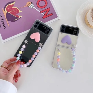 Detail of Galaxy Z Flip case with 3D heart charm and colorful beaded hand chain
