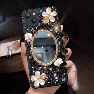 Detail of luxury iPhone case with rhinestone texture, vanity mirror, and pearl flowers