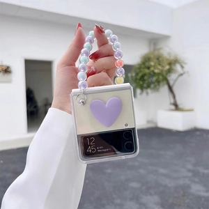 Detail of Galaxy Z Flip case with a large 3D purple heart and colorful beaded chain handle