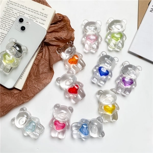 Detailed close-up of transparent resin bear phone sockets with colorful heart centers