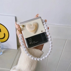 Detail of Galaxy Z Flip case with 3D heart decor and large pearl chain handle