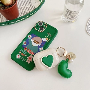 Green iPhone case with mahjong patterns and matching AirPods pro case with plush heart charm