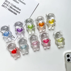 Close-up of clear resin bear phone grips with colorful hearts for DIY craft