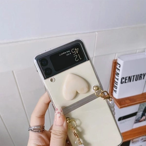 Detailed view of cream Galaxy Z Flip case with 3D heart and elegant pearl chain handle