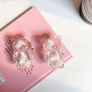 Detailed macro view of resin bear phone grip with sparkling glitter and cream texture