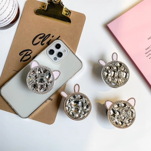 Luxury rhinestone phone socket stand with rabbit and cat ears on white smartphone