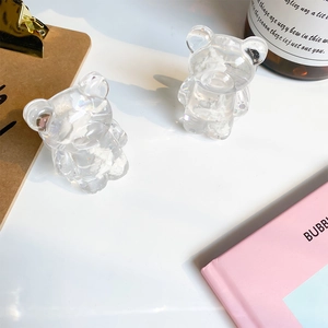 Close-up of bear-shaped phone grip with glitter resin and white cloud filler detail