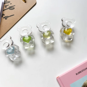 Detailed view of four transparent resin bear phone grips with colorful heart accents