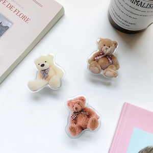 Three cute acrylic bear phone socket grips in cream, brown and red with ribbon bows