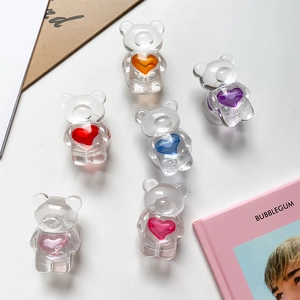 Detailed view of 3D transparent bear phone grips with colorful heart accents