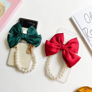 Detail of satin bow and pearl bracelet strap on fold phone case for Z Flip