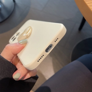 Detail of off-white liquid silicone phone case with a 3D marble texture heart decoration