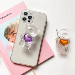 Detailed view of clear resin bear phone grips with purple and orange heart accents