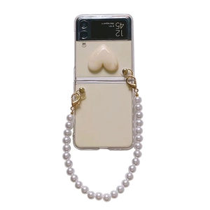 Clear Samsung Z Flip 3 case featuring a cream 3D heart and elegant pearl chain handle