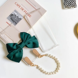 Detail of transparent phone case with green satin bow and pearl wrist strap for Z Flip