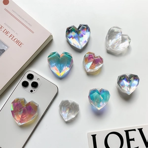 Holographic heart-shaped phone grip with prism cut design on white smartphone back