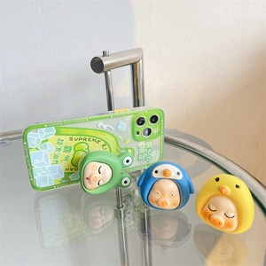 Detailed view of iPhone case with green citrus pattern and three 3D cartoon pig sockets