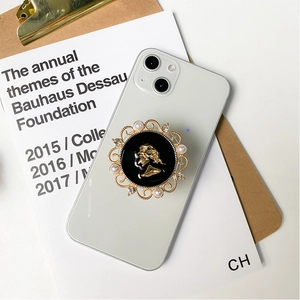 Detail of vintage electroplated phone grip with gold lady cameo and pearl frame