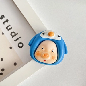 Detail shot of cute 3D pig in blue penguin hat expandable phone grip on grey surface