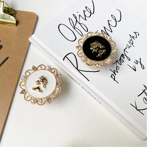 Detailed view of vintage cameo phone socket with gold filigree and pearl accents