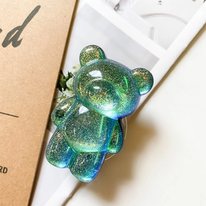 Macro detail of aurora glitter bear phone grip with green and blue gradient finish