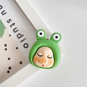 Close-up of cute 3D pig phone socket with frog headwear on white frame background