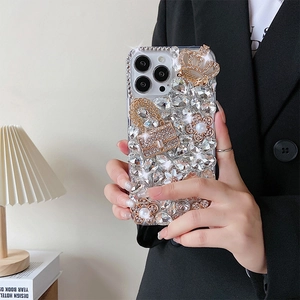 Macro shot of a luxury iPhone case featuring crystal rhinestones, pearls and a golden crown