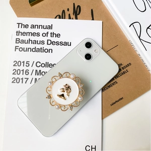 Detail of retro round phone grip with vintage cameo and pearl crystal decoration