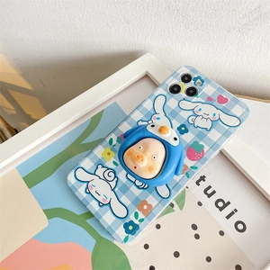Detail of 3D penguin character phone grip on blue plaid Cinnamoroll phone case