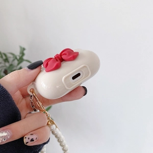 Cream white AirPods Pro case with red bow and elegant long pearl chain lanyard accessory