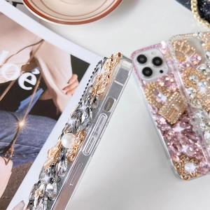 Detailed close-up of luxury iPhone case with pink crystals pearls and gold crown