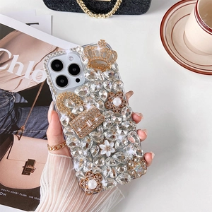 Detail of luxury iPhone case with crystals, pearls, a gold crown and handbag charm