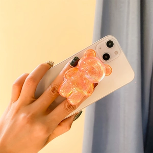 3D glitter bear collapsible phone grip stand in translucent orange pink on a smartphone